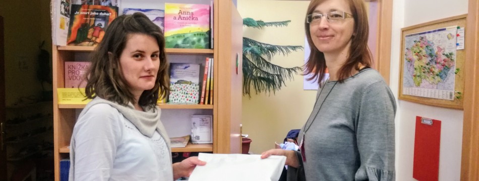 Jana Tlapáková (1. LF UK, na fotografii vpravo) předává dar Mladě Komárkové (Cesta domů)